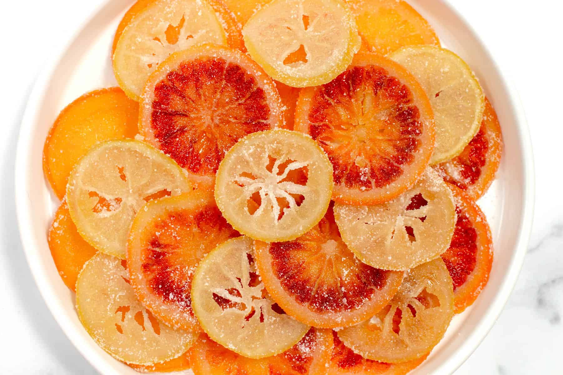 Slices of citrus fruit coated in sweet syrup.