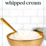 A brown bowl filled with whipped cream sits on a white surface. A spoon is placed within the bowl. The text above reads, "Easy to make the best whipped cream.
