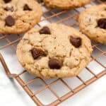 Chocolate chip cookies on a wire cooling rack.