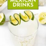 A clear cocktail garnished with spiral-cut lime sits on a white surface, surrounded by sliced and squeezed limes. A green banner reads “17+ Mexican Drinks”—perfect for your next cinco de mayo cocktails celebration.