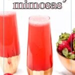 Two glasses of refreshing strawberry mimosas sit enticingly beside a bowl brimming with fresh strawberries.