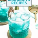 A blue margarita cocktail with ice and a dried lime wheel garnish sits on a wooden coaster; text above reads "25 Margarita Recipes.