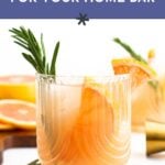A glass of vodka cocktail garnished with rosemary and a grapefruit slice. Text reads: "the best vodka for your home bar." Explore our vodka guide to elevate your mixology skills.