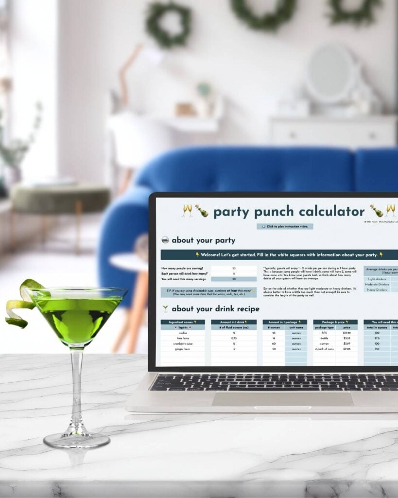 A laptop on a marble table displays a party punch calculator, showcasing Everything I Offer; beside it sits a green cocktail with lime, while a blurred living room completes the inviting scene.