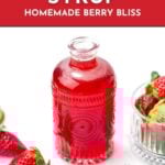 A glass bottle of red strawberry syrup sits beside fresh strawberries and a glass bowl on a white background with text promoting a recipe.