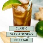 A glass of dark and stormy cocktail with ice, a striped straw, and a lime wedge garnish, next to a lime and a wooden citrus reamer. Text reads: "Classic Dark & Stormy Cocktail.