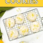 A cooling rack holds six lemon cookies with icing and lemon zest. Text on the image reads "Lemon Cookies. Get the recipe. feastandwest.com." A green cloth is nearby.