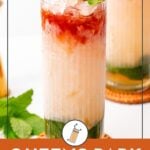A tall glass of Queens Park Swizzle cocktail with crushed ice, mint garnish, and layered colors, set on a coaster with mint leaves beside it.