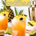 Two tropical cocktails garnished with pineapple, lime, and cherries sit on a white surface with a pineapple, cocktail shaker, and cut limes in the background. Text reads “17+ Tiki Cocktails.”.