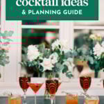 A variety of colorful Signature Cocktails for Weddings in elegant glasses are arranged on a table with floral decorations, beneath a sign that reads "wedding cocktail ideas & planning guide.