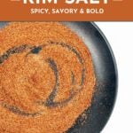 A black plate with a swirl of reddish-brown spice mix labeled as Bloody Mary rim salt; text describes it as spicy, savory, and bold.