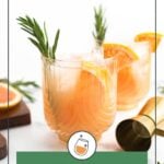 Two glasses of greyhound cocktail garnished with rosemary and grapefruit wedges, with a gold jigger and sliced grapefruit in the background.