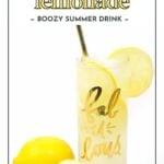 A glass of limoncello lemonade with lemon slices and a straw, next to two whole lemons, against a white background. The glass has "fabulous" written on it in gold.