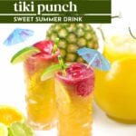 Two colorful glasses of pineapple tiki punch with fruit garnishes and cocktail umbrellas, surrounded by fresh pineapple, lime, lemon, and a pitcher of juice.