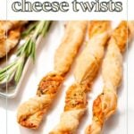 Three golden-brown puff pastry cheese twists are arranged on a white surface with a sprig of rosemary beside them.