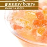 A close-up of a glass bowl filled with champagne gummy bears in a fizzy, sparkling liquid. Text overlay reads "champagne gummy bears, sparkly & boozy.