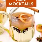 A glass of Fall Mocktail garnished with a dried orange slice, star anise, and a cinnamon stick, elegantly served in a gold cup.