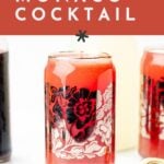 A glass with a red Monaco cocktail sits on a white surface, surrounded by bottles. Text reads “How to make a Monaco Cocktail recipe. Get the details at feastandwest.com.”.