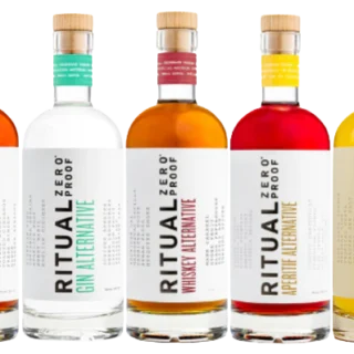 Five bottles of Ritual Zero Proof alcohol alternatives, labeled as rum, gin, whiskey, aperitif, and tequila, are arranged in a row against a white background.