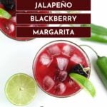 Overhead view of two glasses of red jalapeño blackberry margarita with ice, blackberries, and lime; jalapeño slices in a jar, limes, and a jalapeño pepper nearby.