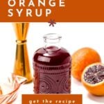 A glass bottle of blood orange syrup is surrounded by a sliced blood orange, a citrus squeezer, and a jigger, with text about making blood orange syrup and getting the recipe.