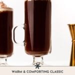 A glass mug of Irish coffee topped with whipped cream sits next to a gold jigger on a white background. Text reads: "Warm & Comforting Classic Irish Coffee Cocktail.