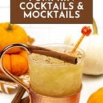 A pumpkin cocktail in a copper mug, garnished with a cinnamon stick, is surrounded by small pumpkins and cinnamon sticks, featuring a sign that reads "16 Pumpkin Cocktails & Mocktails" to inspire your next pumpkin cocktails and mocktails adventure.