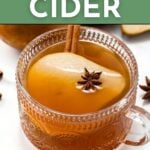 A glass cup of pear cider garnished with a pear slice, cinnamon stick, and star anise, with "Pear Cider" and "Get the Recipe" text above and below the image.
