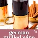 Two glass mugs of German mulled wine with cinnamon sticks, next to a bowl of cinnamon sticks, on a white surface. Text overlay reads: "German Mulled Wine - Rich Spiced Elixir.