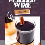 A glass mug filled with German mulled wine topped with a cinnamon stick, set against a purple background with the text "German Mulled Wine Recipe.