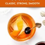 Top-down view of an Old Fashioned cocktail with an orange peel, ice, and a cherry, garnished with a decorative spoon. Text overlay advertises a classic cocktail recipe.