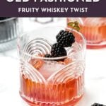 A glass of blackberry old-fashioned cocktail garnished with blackberries on a cocktail pick sits on a white surface; text describes a fruity whiskey twist and invites to get the recipe.