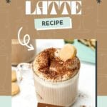 A glass mug of tiramisu latte topped with whipped cream, cocoa powder, and a ladyfinger cookie, with text reading "Tiramisu Latte Recipe.