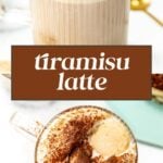 A glass mug of tiramisu latte topped with whipped cream and cocoa powder, with a hand dipping a ladyfinger biscuit into the drink.