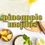 A glass of pineapple mojito garnished with a pineapple slice and mint, surrounded by fresh pineapple, lime, and mint leaves on a white surface. Text overlay reads "pineapple mojitos.