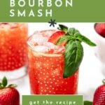 A glass of strawberry bourbon smash garnished with fresh basil sits on a white surface, surrounded by strawberries. Text overlay reads, "How to make a strawberry bourbon smash.
