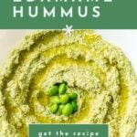 A bowl of green edamame hummus topped with whole edamame beans and a drizzle of olive oil.