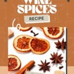 Dried orange slices, star anise, cinnamon sticks, and sugar cubes on a white surface with text about mulled wine spices.