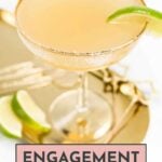 A cocktail with a sugared rim and lime wedge on a gold tray, labeled "Engagement Party Drinks.