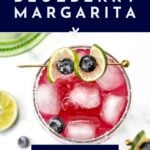 Top view of a blueberry margarita with lime and blueberries, text reads “how to make a blueberry margarita.”.