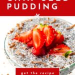 Glass bowl of chia seed pudding topped with sliced strawberries and chocolate shavings on white background.