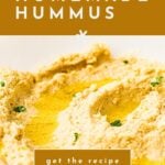 Bowl of creamy homemade hummus garnished with herbs; text reads “how to make homemade hummus.”.
