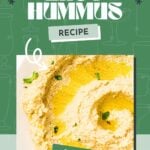 Bowl of creamy hummus drizzled with olive oil and sprinkled with herbs on a green background.