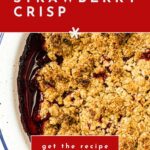 Strawberry crisp dessert with oat topping in a white dish, text overlay reads “how to make a strawberry crisp.”.