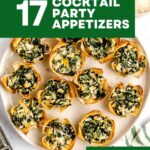 A plate of mini phyllo cups filled with spinach dip, captioned “17 Cocktail Party Appetizers.”.