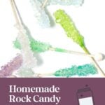 Colorful rock candy sticks arranged on a white surface with a text overlay for homemade rock candy recipe.