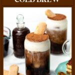 Iced tiramisu cold brew in glass mugs topped with cream, cocoa, and ladyfingers, with dessert on the side.
