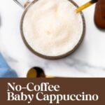 A glass mug of foamy milk with a golden spoon, titled “No-Coffee Baby Cappuccino.”