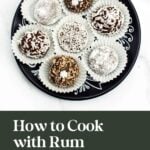 A black plate holding assorted round rum balls in paper cups, with text reading “How to Cook with Rum.”