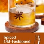 An Old-Fashioned cocktail garnished with cinnamon, orange peel, cloves, and star anise.
